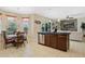 Dining area adjacent to the kitchen with chandelier and wicker chairs, connecting seamlessly to the living space at 4018 Chandler Estates Dr, Apopka, FL 32712