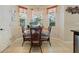 Bright dining area with chandelier, glass table, and wicker chairs, offering views of the outdoor space at 4018 Chandler Estates Dr, Apopka, FL 32712