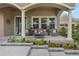 Charming front porch with decorative plants and cozy seating, perfect for relaxing outdoors at 4018 Chandler Estates Dr, Apopka, FL 32712