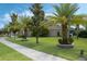 Manicured front yard showcasing lush green grass and decorative landscaping with several palm trees at 4018 Chandler Estates Dr, Apopka, FL 32712