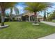 Beautiful home featuring a well-manicured lawn and lush landscaping with palm trees at 4018 Chandler Estates Dr, Apopka, FL 32712