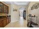 Inviting hallway with neutral tones, tiled floor, and decorative wall art leading to the front entrance at 4018 Chandler Estates Dr, Apopka, FL 32712