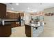 Spacious kitchen featuring dark wood cabinetry, granite countertops, stainless steel appliances, and a center island at 4018 Chandler Estates Dr, Apopka, FL 32712