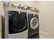 Modern laundry room featuring front loading LG washer and dryer with storage shelves above at 4018 Chandler Estates Dr, Apopka, FL 32712