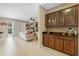 Stylish built-in bar with glass-front cabinets complements the open living space with neutral colors at 4018 Chandler Estates Dr, Apopka, FL 32712