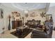 Elegant living room featuring a decorative tray ceiling, stylish chandelier, and ornate furniture at 4018 Chandler Estates Dr, Apopka, FL 32712