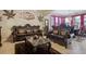 Elegant living room boasts stylish furnishings, decorative art, and a bright, airy ambiance at 4018 Chandler Estates Dr, Apopka, FL 32712