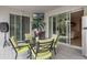 Patio with a dining table, comfortable seating, sliding glass doors and a small tv mounted on the wall at 4018 Chandler Estates Dr, Apopka, FL 32712