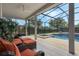 Enclosed patio features comfortable seating, a ceiling fan, and view of the pool and spa at 4018 Chandler Estates Dr, Apopka, FL 32712