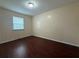 This bedroom has wood-look floors and a window to let in light at 402 E Maple St, Winter Garden, FL 34787