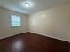 This bedroom has wood-look floors and a window to let in light at 402 E Maple St, Winter Garden, FL 34787