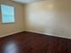 Bedroom featuring hardwood floors and natural light from a window at 402 E Maple St, Winter Garden, FL 34787