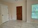 Bright room with marble floors, window, and a wood-paneled front door at 402 E Maple St, Winter Garden, FL 34787