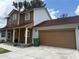 Side view of home with attached garage, showcases the home's architecture and curb appeal at 402 E Maple St, Winter Garden, FL 34787