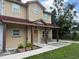 Charming two-story home with a covered front porch and seating at 402 E Maple St, Winter Garden, FL 34787