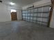 Garage featuring concrete flooring and an insulated overhead garage door at 402 E Maple St, Winter Garden, FL 34787