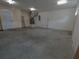 Garage featuring concrete flooring, air conditioning, and garage door at 402 E Maple St, Winter Garden, FL 34787