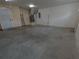 Garage featuring concrete flooring, air conditioning, and garage door at 402 E Maple St, Winter Garden, FL 34787