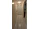 Hallway featuring white marble tile floor, leading to door and bathroom at 402 E Maple St, Winter Garden, FL 34787