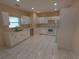 Bright kitchen featuring white cabinets and appliances at 402 E Maple St, Winter Garden, FL 34787
