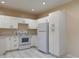 Bright kitchen featuring white cabinets and appliances at 402 E Maple St, Winter Garden, FL 34787