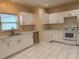 Bright kitchen featuring neutral walls, recessed lighting, white cabinets, and tile flooring at 402 E Maple St, Winter Garden, FL 34787