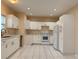 Spacious kitchen featuring stainless appliances, white cabinets, recessed lighting, and tile flooring at 402 E Maple St, Winter Garden, FL 34787