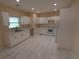 Bright kitchen featuring white cabinets, modern appliances, recessed lighting, and tile flooring at 402 E Maple St, Winter Garden, FL 34787