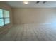 Spacious living room featuring neutral walls, recessed lighting, and bright natural light through the window at 402 E Maple St, Winter Garden, FL 34787