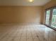 Bright living room featuring neutral paint, tile flooring, and glass doors leading to the exterior at 402 E Maple St, Winter Garden, FL 34787