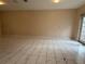 Spacious living room featuring neutral paint, tile flooring, and doors leading to the backyard at 402 E Maple St, Winter Garden, FL 34787