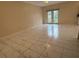 Open living room with neutral paint, tile flooring, and doors leading to the backyard space at 402 E Maple St, Winter Garden, FL 34787