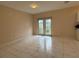 Bright living room featuring recessed lighting, neutral paint, tile flooring, and glass doors at 402 E Maple St, Winter Garden, FL 34787