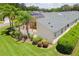 Aerial view of the landscaped backyard and screened-in patio with view of the roof and lawn at 425 Glen Arbor Ln, Leesburg, FL 34748