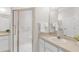 Bathroom with neutral vanity countertop, brushed metal faucet, and glass shower enclosure at 425 Glen Arbor Ln, Leesburg, FL 34748