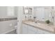 Bathroom featuring neutral vanity countertop, framed mirror, and toiletry dispenser at 425 Glen Arbor Ln, Leesburg, FL 34748
