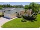 Charming home showcases a lush green lawn, mature landscaping, and a screened-in porch ideal for outdoor living at 425 Glen Arbor Ln, Leesburg, FL 34748