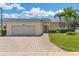 Beautifully landscaped home boasts a brick driveway, a spacious two-car garage, and a well-manicured lawn at 425 Glen Arbor Ln, Leesburg, FL 34748