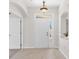 Bright foyer featuring tile flooring, a chandelier, and a view of the entryway with transom window above door at 425 Glen Arbor Ln, Leesburg, FL 34748