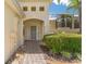 Inviting front entrance with a brick pathway leading to the front door, complemented by lush landscaping at 425 Glen Arbor Ln, Leesburg, FL 34748