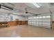 Spacious garage featuring ample storage, a ceiling fan, and an automatic door at 425 Glen Arbor Ln, Leesburg, FL 34748