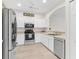 Bright kitchen featuring stainless steel appliances and white cabinetry at 425 Glen Arbor Ln, Leesburg, FL 34748