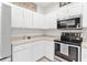 Stylish kitchen with stainless steel appliances and white cabinetry at 425 Glen Arbor Ln, Leesburg, FL 34748