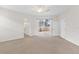 Spacious carpeted living room with slider doors to the lanai at 425 Glen Arbor Ln, Leesburg, FL 34748