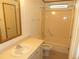The bathroom has a vanity, toilet, tub and shower combination, and a grab bar at 432 Santa Fe E Rd, Tavares, FL 32778