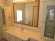 This bathroom features a vanity with cabinets, a large mirror, and wallpapered walls at 432 Santa Fe E Rd, Tavares, FL 32778