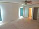 Bedroom featuring neutral carpeting, a ceiling fan, and a closet at 432 Santa Fe E Rd, Tavares, FL 32778