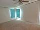 Bedroom featuring neutral carpeting, a ceiling fan, and natural lighting at 432 Santa Fe E Rd, Tavares, FL 32778