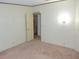This bedroom has light-colored walls, carpeted floor, and an open closet at 432 Santa Fe E Rd, Tavares, FL 32778