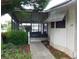 Well-maintained home featuring a screened-in porch and neatly landscaped yard at 432 Santa Fe E Rd, Tavares, FL 32778